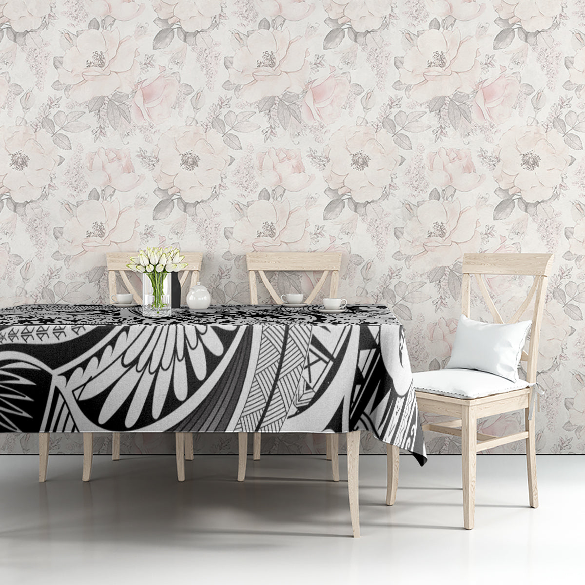 Tribal tablecloth with black-and-white tiki pattern and white floral accents on table