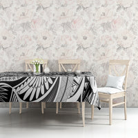Tribal tablecloth with black-and-white tiki pattern and white floral accents on table