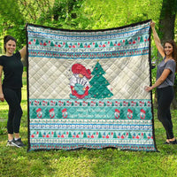 Christmas musical quilt blanket with quilted snowman and tree in green, red, and mint blue