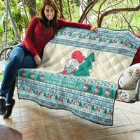 Christmas quilt blanket laid over sofa with snowman and tree motif, mint blue decorative trim