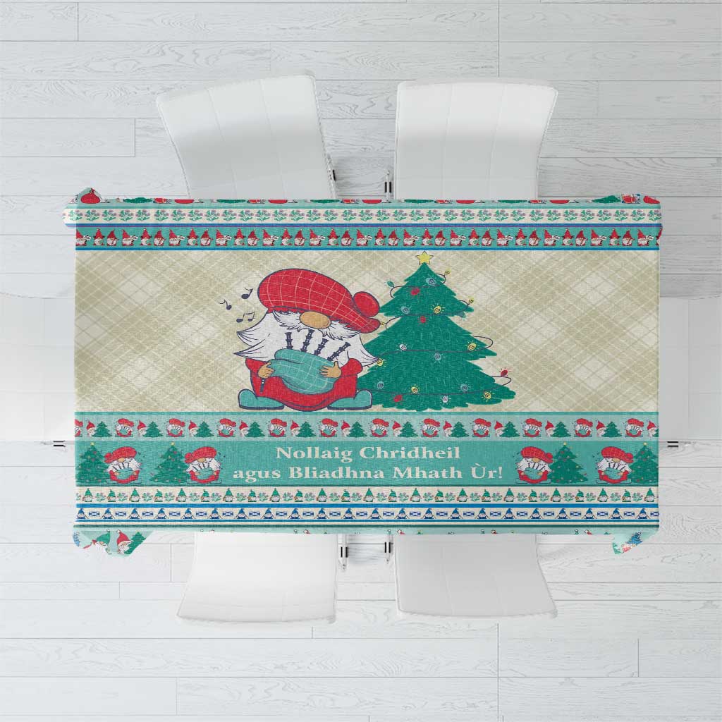 Christmas gnome tablecloth with red-nosed gnome, trees, and mint-blue patterned border.