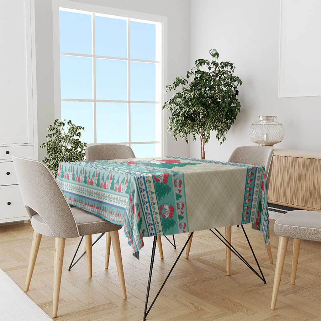 Christmas gnome tablecloth in mint blue draped on a rectangular dining table with chairs.
