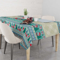 Christmas gnome tablecloth, mint blue and teal, with tree-and-stripe pattern along table edge.