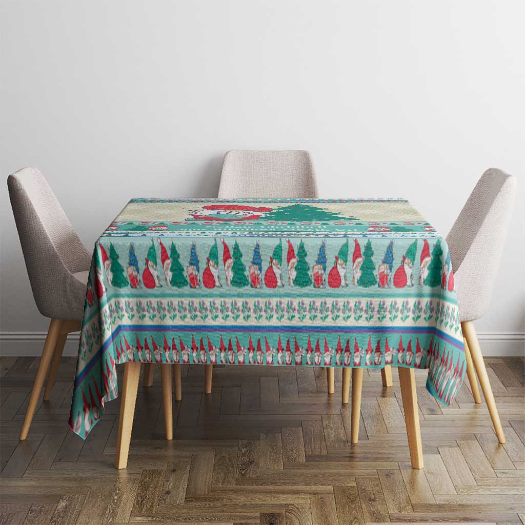 Rectangular Christmas gnome tablecloth in mint blue with red and green tree stripe border.