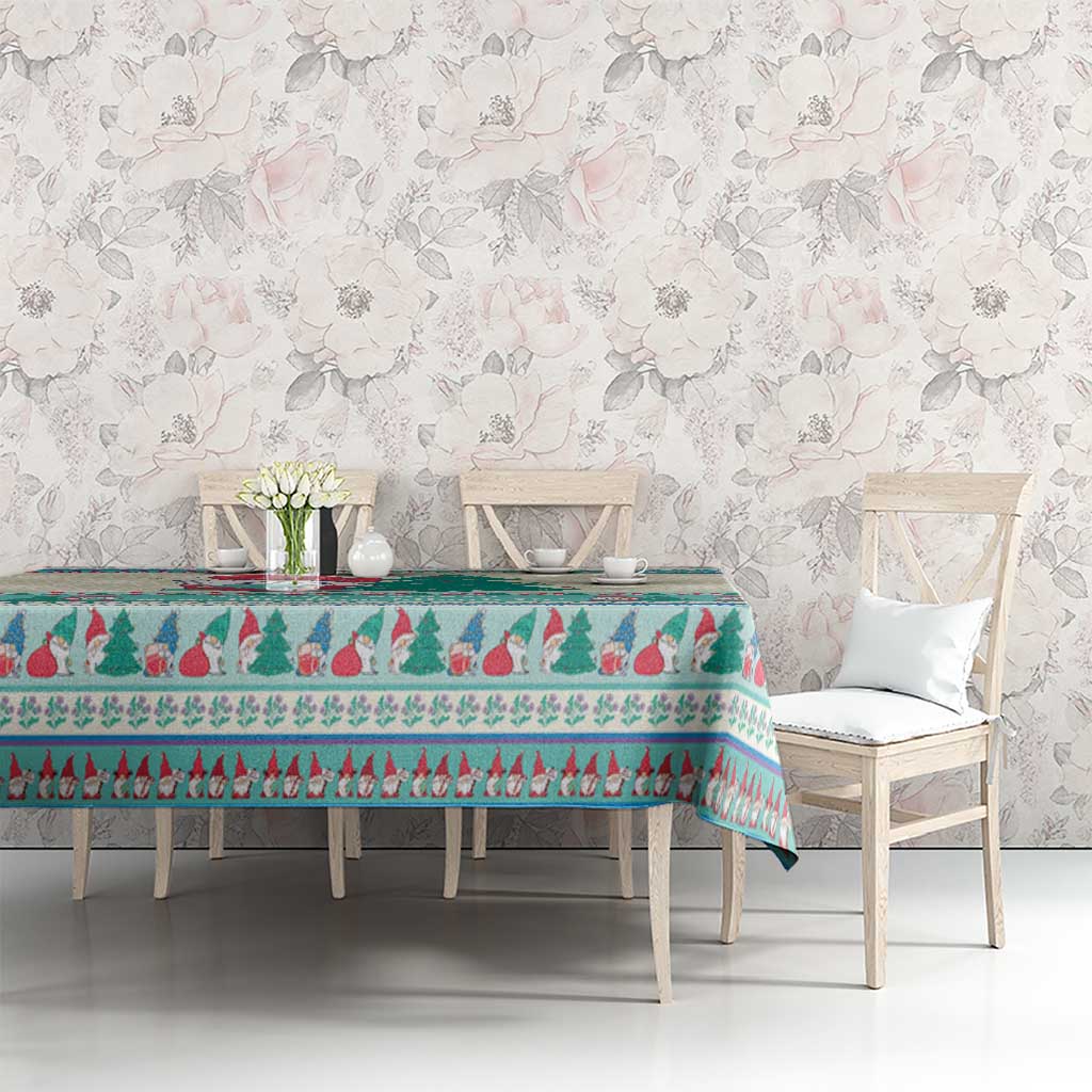 Christmas gnome tablecloth in mint blue over dining table, featuring tree and border motifs.