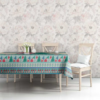 Christmas gnome tablecloth in mint blue over dining table, featuring tree and border motifs.