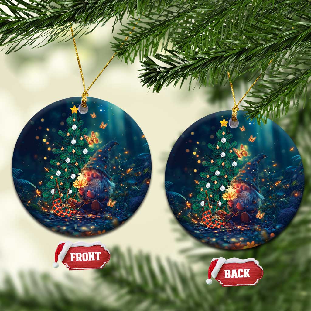 Dark blue round ceramic Christmas ornament with gnome, decorated tree, star lights, gold cord