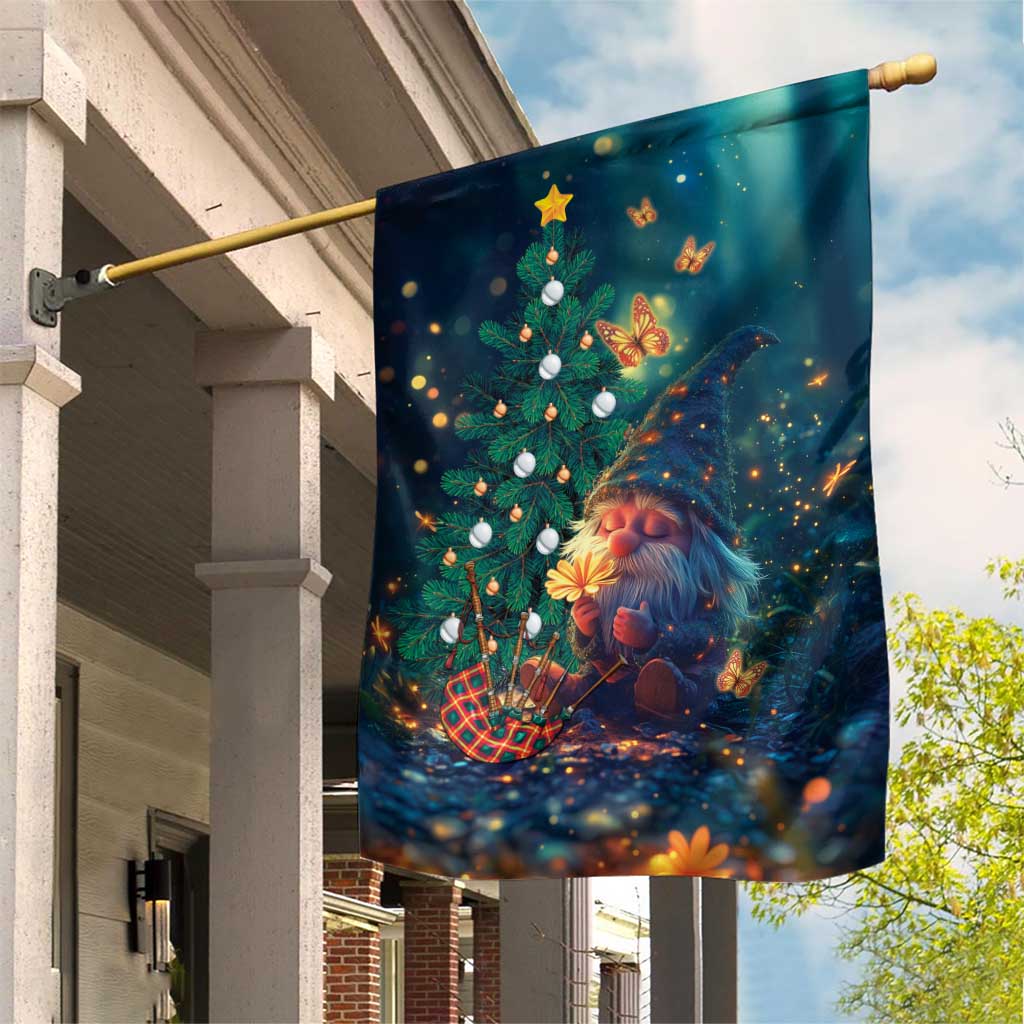 Dark green Christmas garden flag featuring gnome, decorated tree, butterflies, warm lights