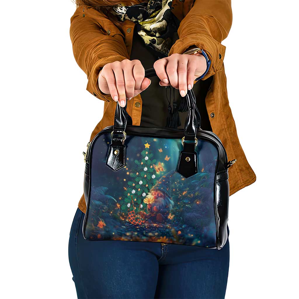 Blue handbag with black top handles and gold-tone studs, with holiday tree artwork.