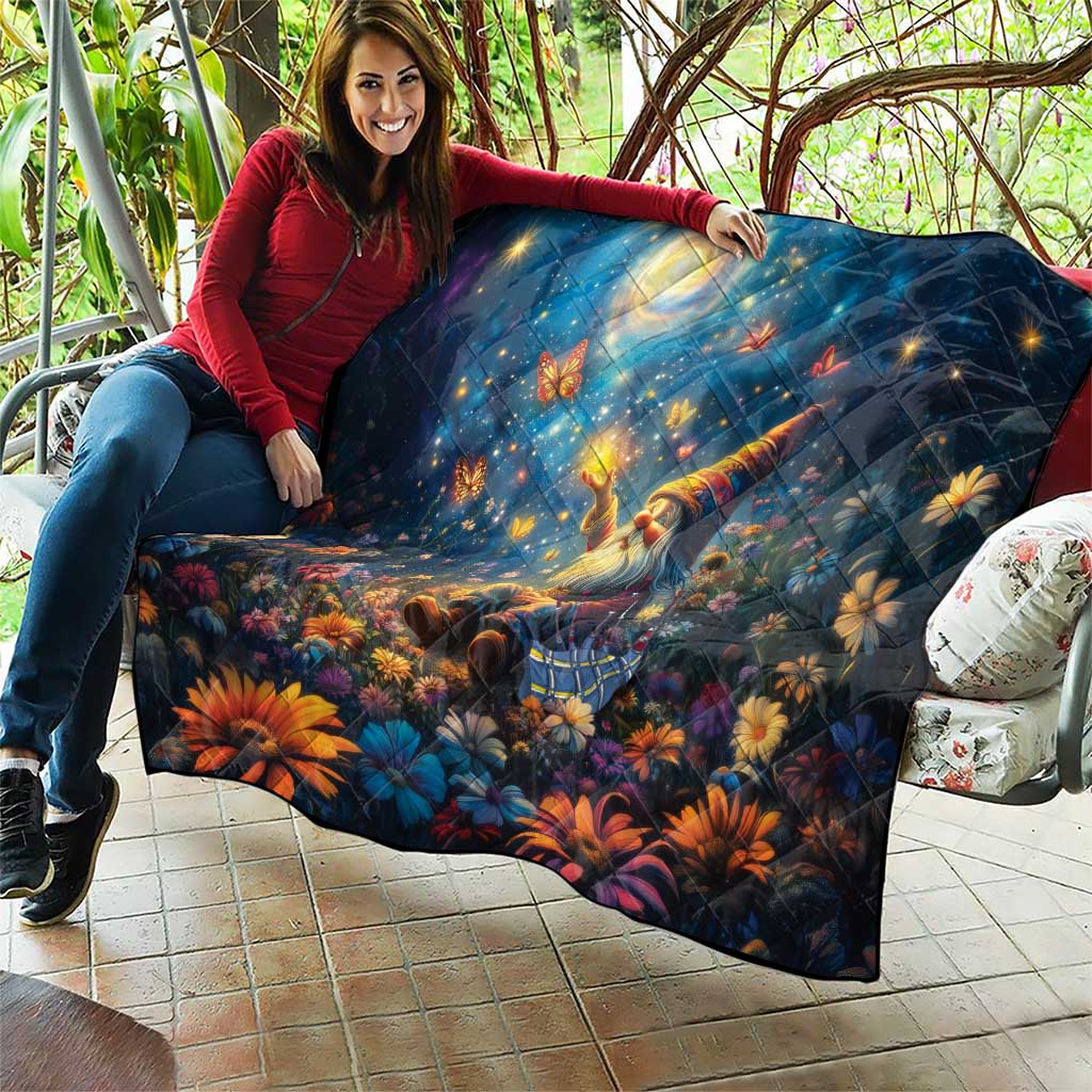 Blue quilt with starry night scene, glowing moon, angel, and colorful flowers