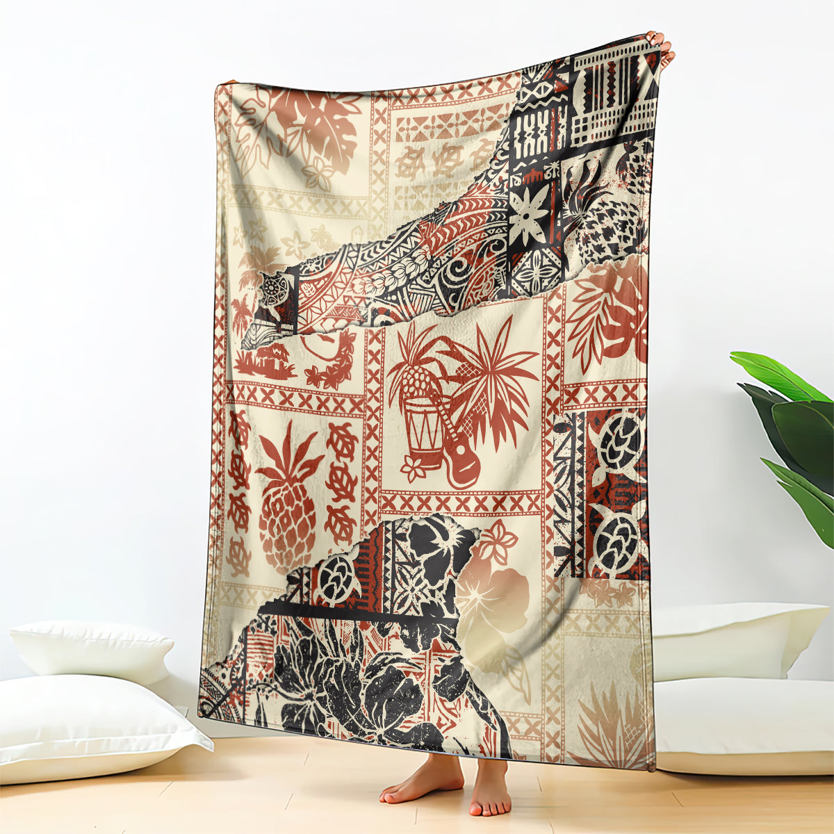 Beige blanket with red and black tribal patchwork pattern, draped on bed