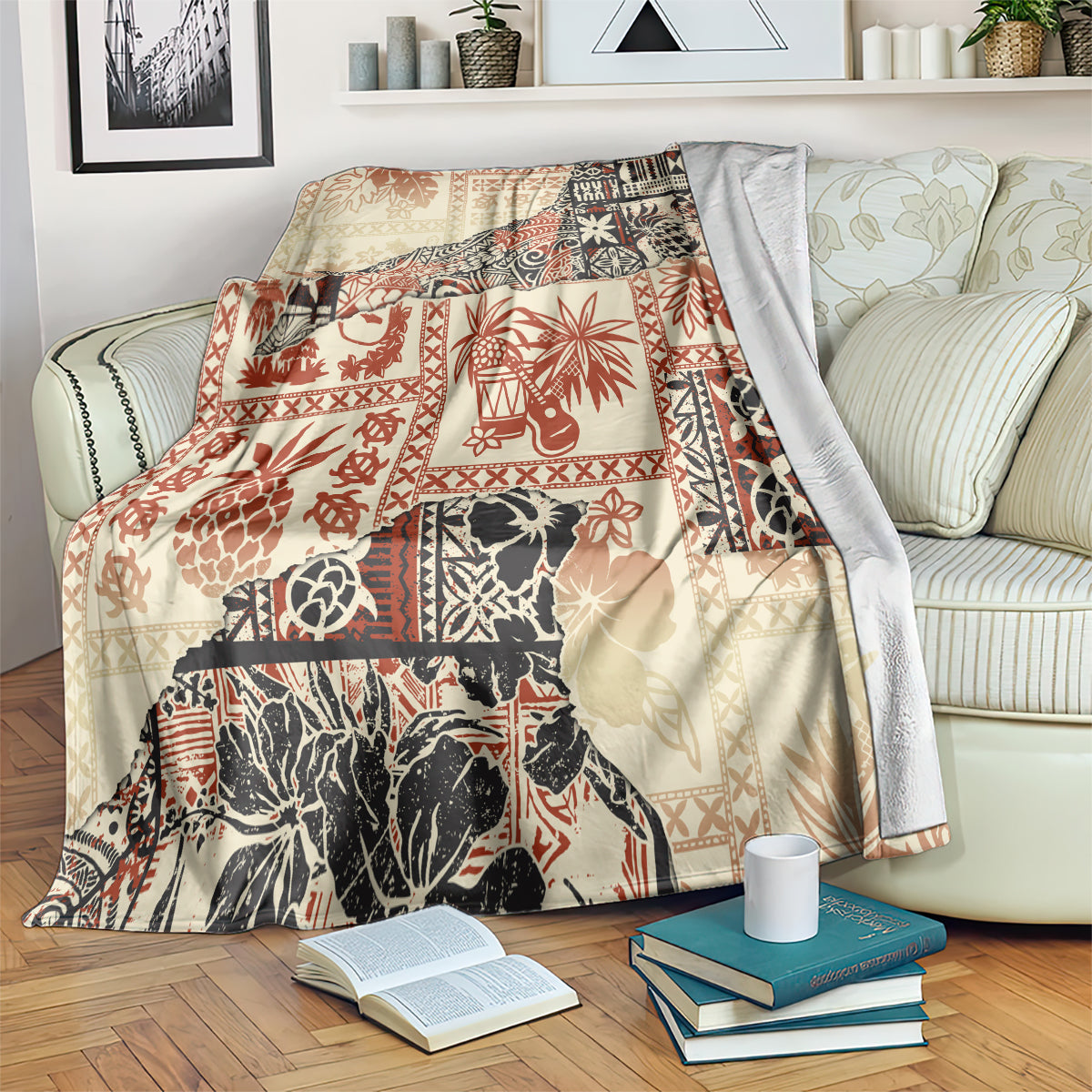 Beige blanket with red and black jungle tribal patchwork, folded over arm