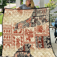 Beige quilt with red, black, and white aloha tribal patchwork patterns and diamond stitching