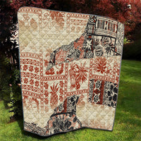 Beige quilted aloha tribal blanket with red, black, and white square and border prints