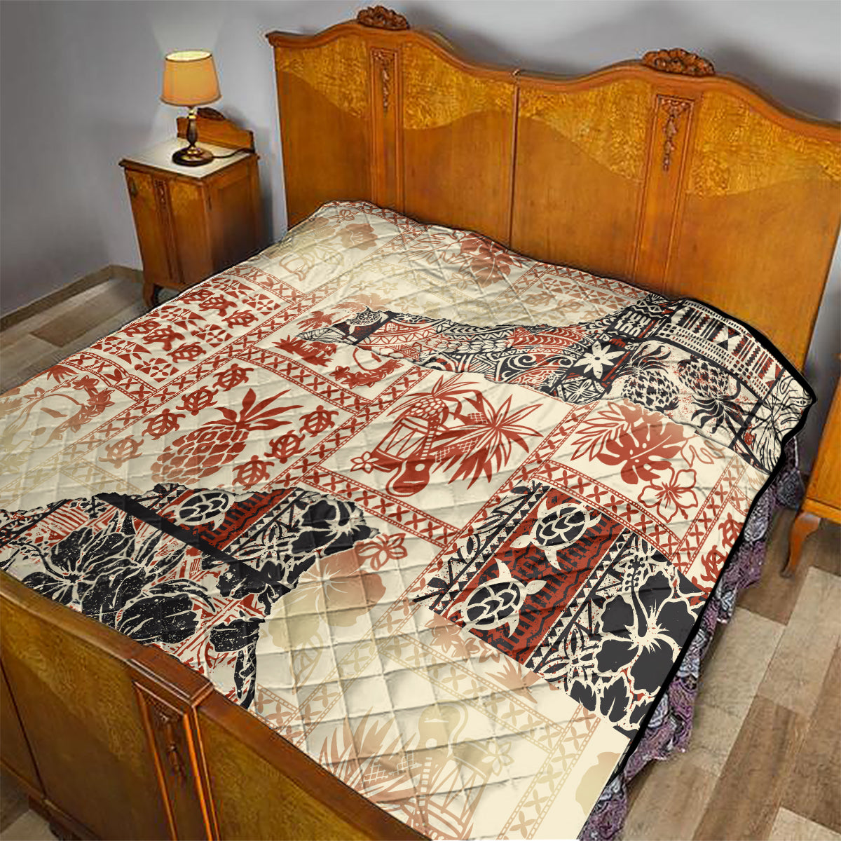 Beige and red aloha tribal quilt on bed with quilted diamond texture and black border