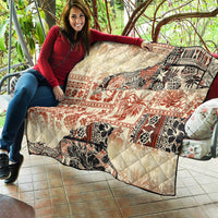 Beige aloha tribal quilt blanket with red floral and black animal motifs and quilted surface
