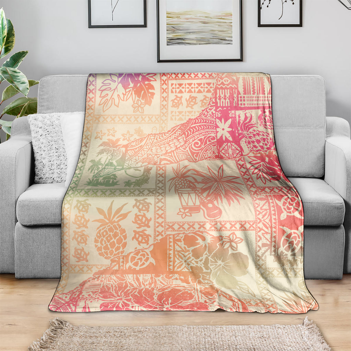 Pink ombre tropical blanket with patchwork floral and palm motifs, laid over couch