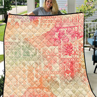 Hawaiian quilt blanket with pink-to-cream ombre and tribal floral pattern, diamond quilting