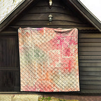 Hawaiian quilt blanket with pink-red and cream ombre tribal pattern, black binding, diamond quilted