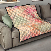 Hawaiian quilt blanket draped on sofa, pink and cream ombre tribal pattern with black trim, quilted