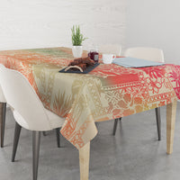 Hawaii tablecloth on dining table with pink, orange, and beige leaf pattern