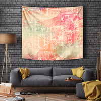 Pink ombre tapestry with tribal patchwork patterns and animal, plant, and island motifs