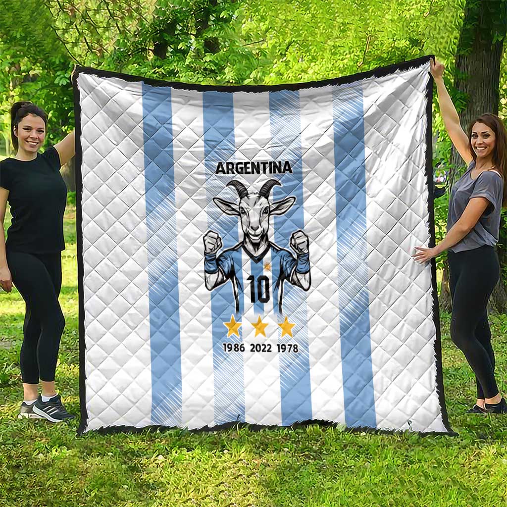 Argentina quilt blanket spread outdoors: white base, light blue vertical stripes, goat 10 crest