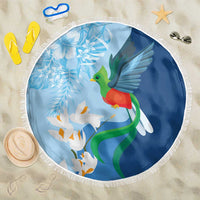 Blue circular beach blanket with fringe, quetzal bird, white lilies, and blue floral print