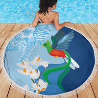 Blue round beach blanket with fringe edge, quetzal bird and white lily blooms print
