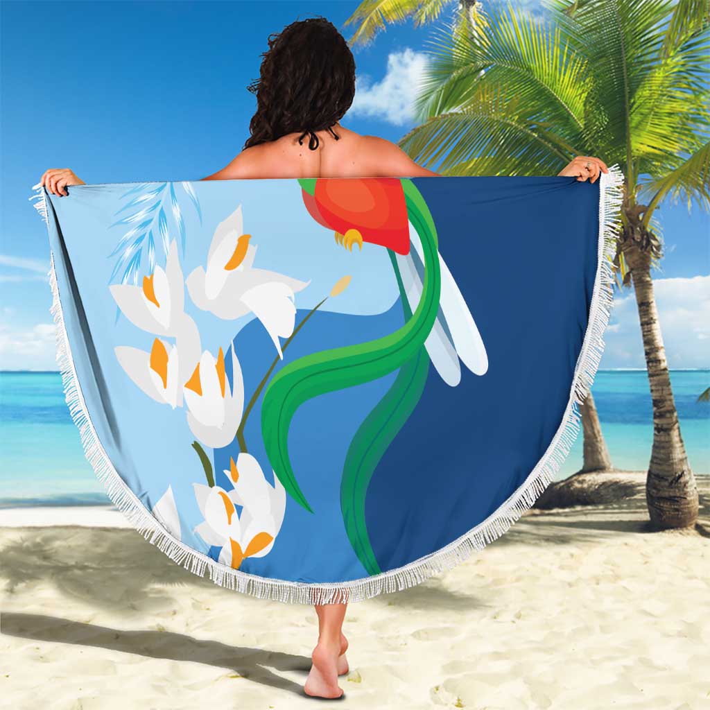 Blue round beach blanket with fringe edge, quetzal bird and white flowers illustration