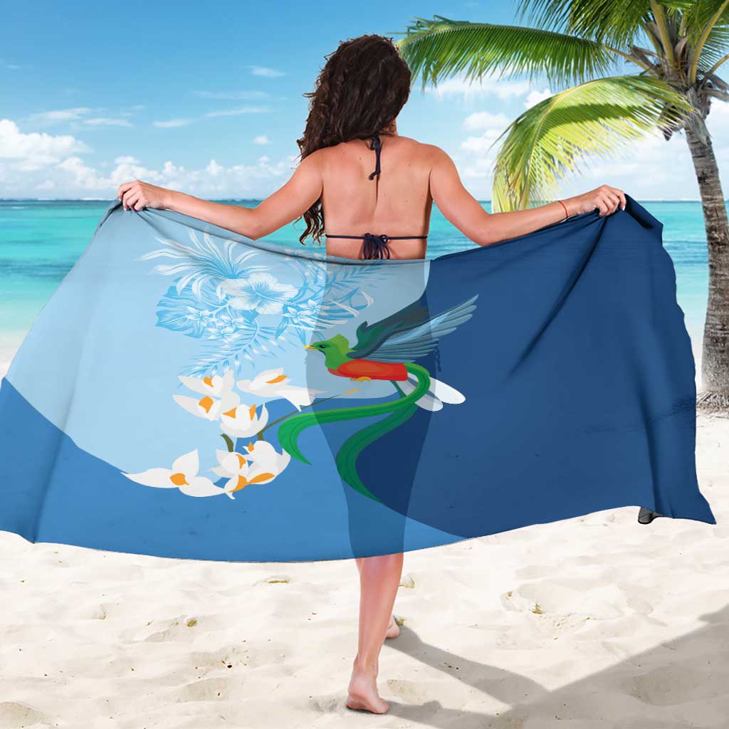 Blue bird-and-flower sarong wrap with large quetzal print, shown from behind