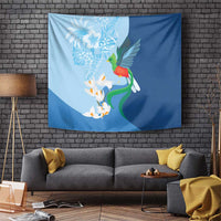 Blue hanging tapestry with green bird, white blossoms, and orange accents