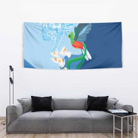Blue tapestry with green bird artwork and white flowers with orange details