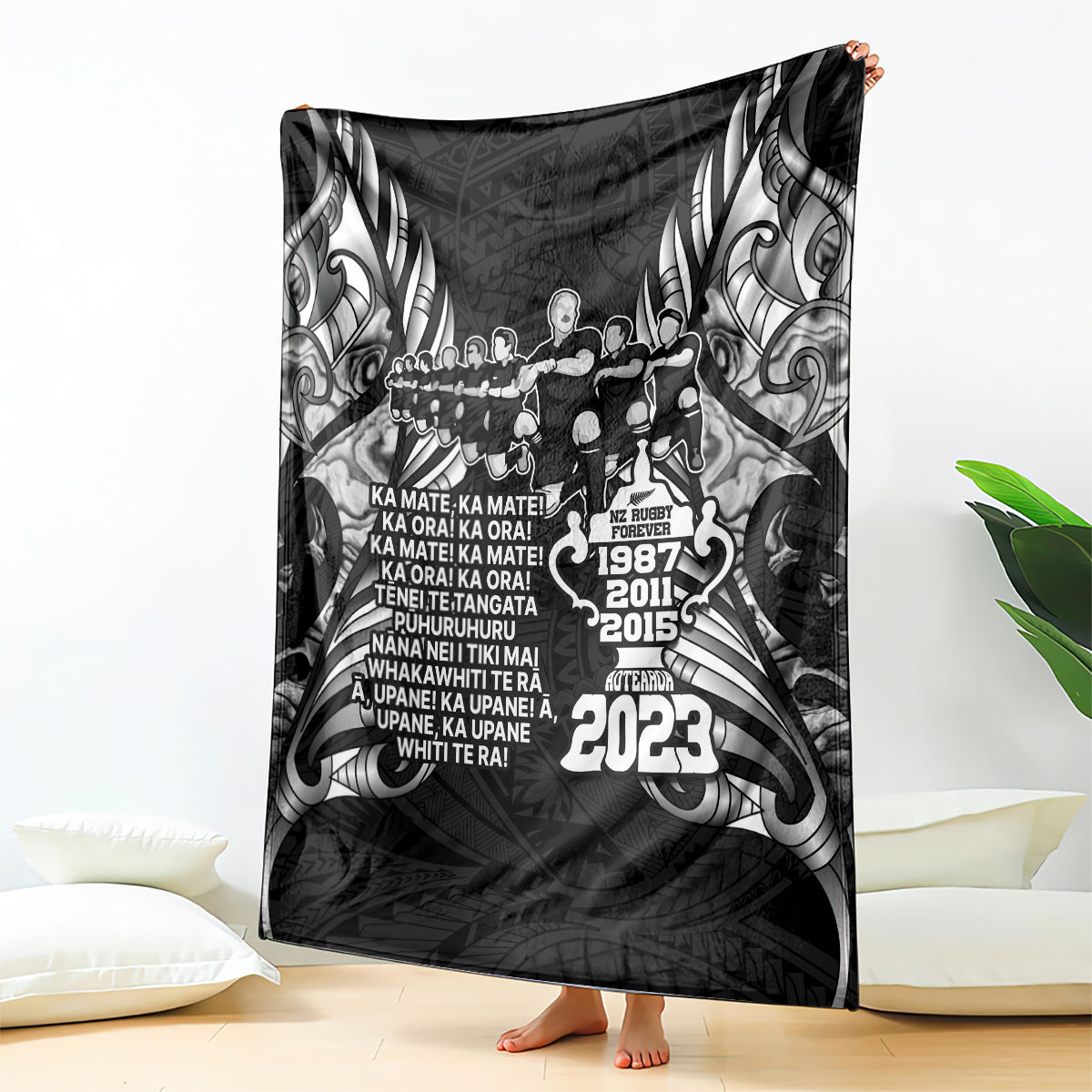 Black rugby haka style throw blanket with grayscale tribal artwork and text crest on center