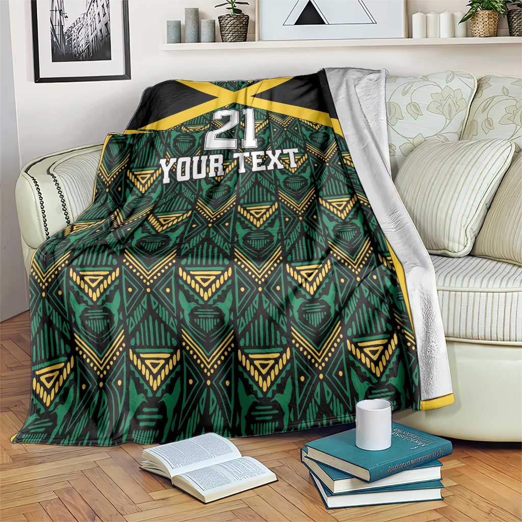 Custom football blanket over bed, black with yellow X, green motifs, '21 Your Text'.
