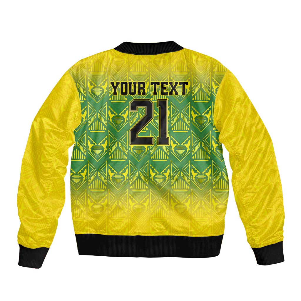Gold bomber jacket back with green tribal pattern and black ribbed hem, zip-up