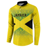 Gold button-up sweatshirt with Jamaica crest graphic, X-shaped accents, patterned sleeves
