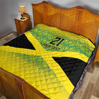 Bed quilt with green geometric print on top, yellow X stripe, black lower section, "21" and text.