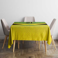 Custom gold tablecloth with green geometric reggae pattern, covering dining table