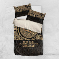 Flat-lay black duvet bedding set with gold Aztec pattern and two pillowcases