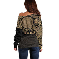 Women’s off-shoulder sweater, dark back with gold circular Aztec design and “YOUR TEXT”