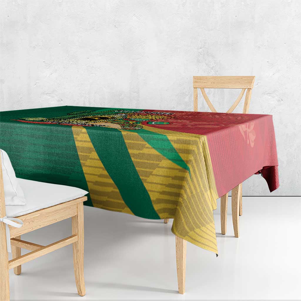 Green and yellow diagonal striped tablecloth with red edge, draped over table