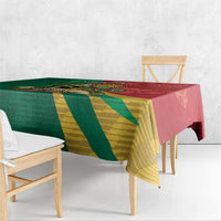 Green and yellow diagonal striped tablecloth with red edge, draped over table