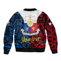 Black bomber jacket with red and blue Polynesian back graphic, crest emblem, ribbed hem