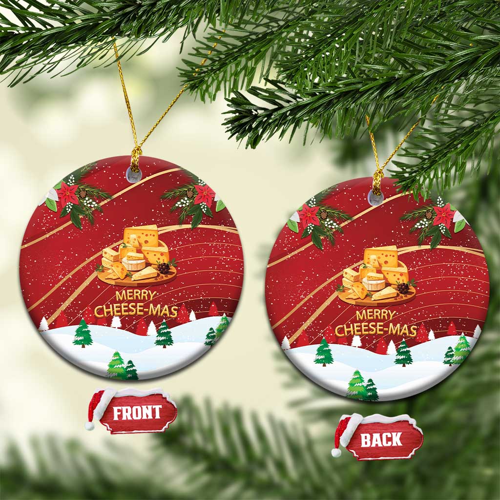 Red ceramic round “Merry Cheese-Mas” ornament with holly and cheese graphic, gold string.