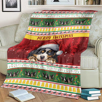 Red Bernese mountain dog Christmas blanket draped on couch, 'Merry Swissmas' center text strip.