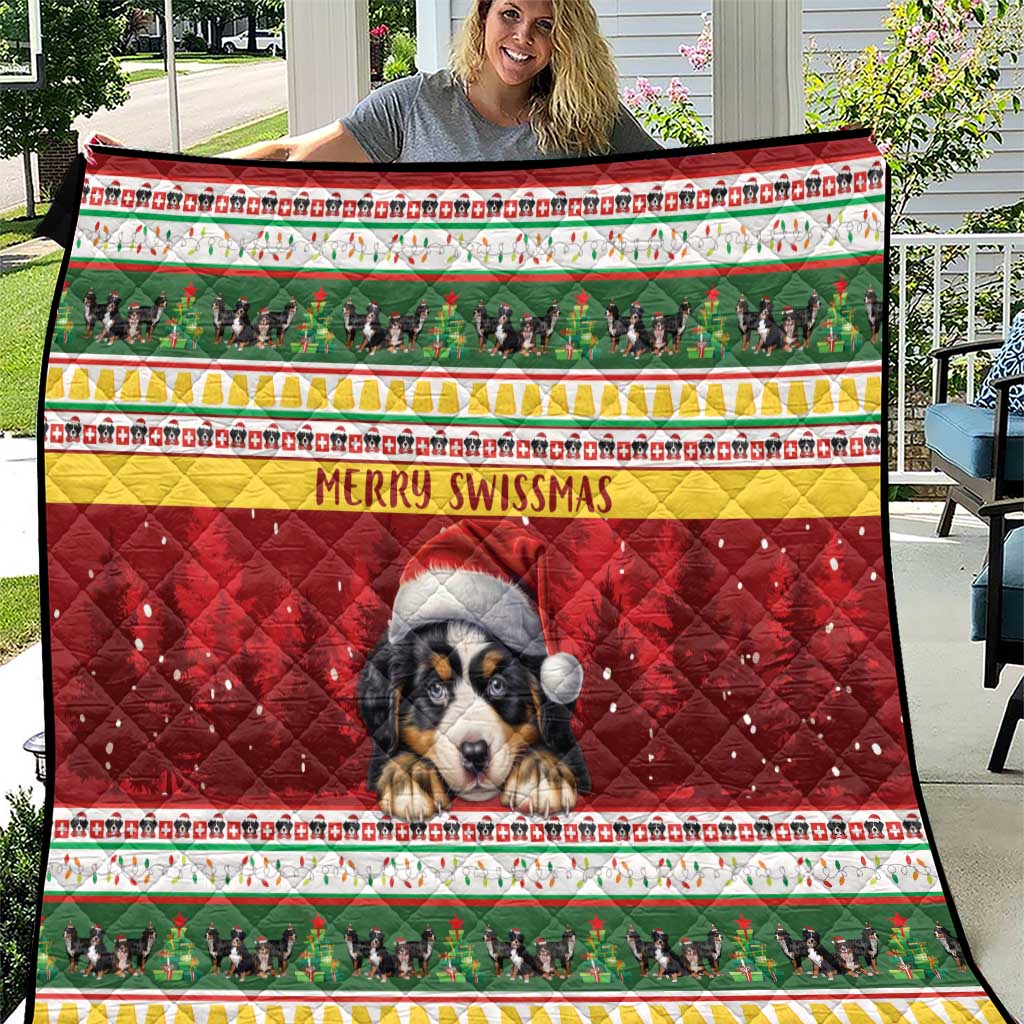 Red Christmas quilt held up outdoors, featuring Bernese mountain dog, green border, and "Merry Swissmas"