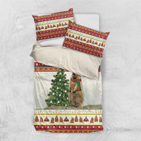 Folded Christmas bedding set: white duvet cover with red trim, dog with scarf, pine tree panel