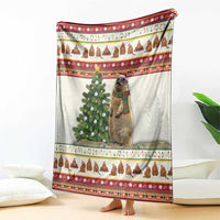 Folded Christmas blanket with marmot, fir tree, and colorful holiday border stripes