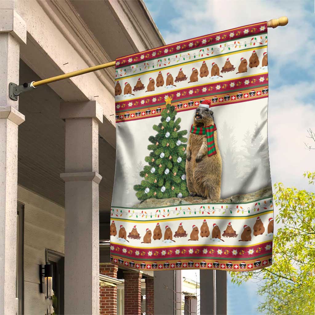 Christmas garden flag with marmot in plaid scarf and decorated evergreen tree, red border